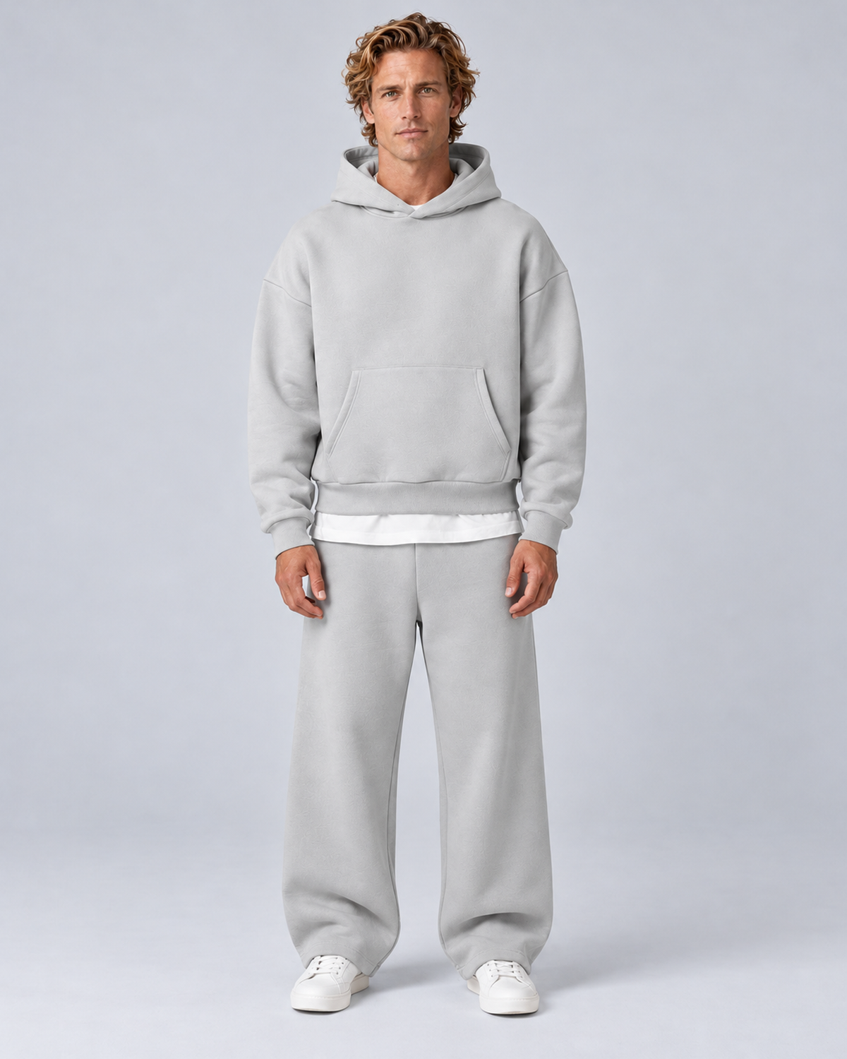 Men's pullover hoodie and straight-leg tracksuit set in light grey, front hero, on approved studio model