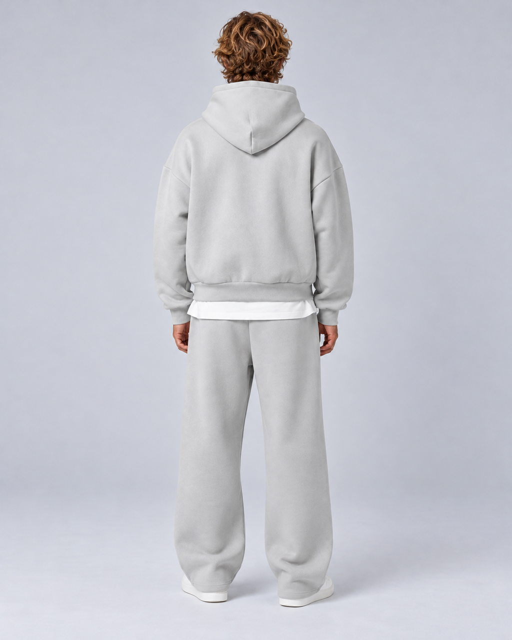 Men's pullover hoodie and straight-leg tracksuit set in light grey, rear full-length, on approved studio model